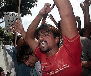 A group of youth hold a demonstration to condemn the killing of two brother by mob in Sialkot, Pakistan. AP