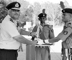 Shashank Shekhar Sharma (right), school captain, receives the trophy for the best all-round cadet from Air Marshal J Chauhan