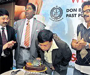 Actor Y Gee Mahendran blows out candles on a cake to celebrate his 60th birthday at a past pupils meeting in Don Bosco School, Egmore on Saturday. For