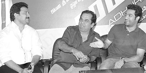 Actor NTR Jr sharing a joke along with producer Vallabhaneni Vamsi Mohan, Bramhanandam and VVVinayak at sucess meet of the film Adhurs in the city.