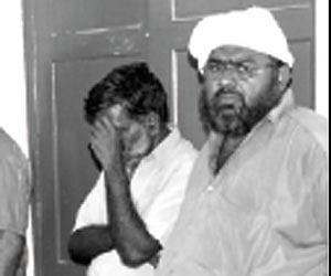 The arrested persons and (Right) the carved ivory box seized from them.