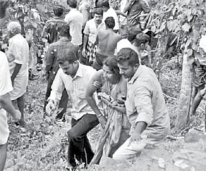 A woman who was pulled out from the river being led to the ambulance.