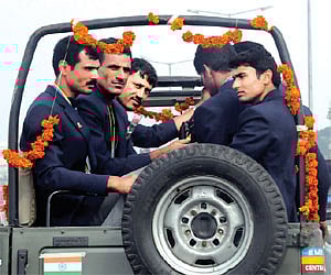 The Guangzhou Asian Games Indian medal winners Saji Thomas, Bajrang Lal Takhar, coach Ismail Baig and Giriraj riding back to Boat Club in City. EPS