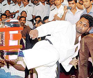 Midhun Jith attempting for a Guinness World Record in martial arts kicks at the Town Hall in Kochi on Friday.