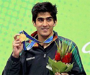 Vijender Singh shows his gold medal that he won in the men's 75kg category. PTI Photo