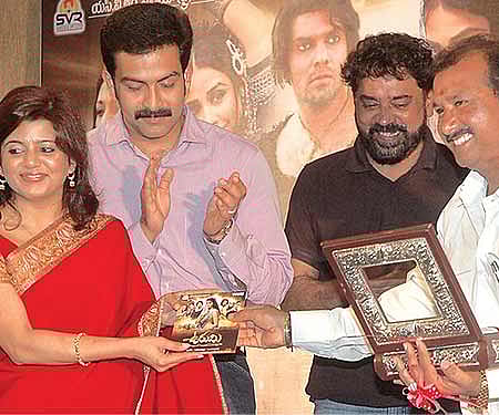 Telugu film director Samundra handing over the audio CD of the film to actor Prithviraj’s wife at a function in the city| Sai Ramesh.