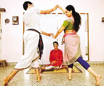 A Lakshmanaswamy watches as his  disciples practice a dance sequence