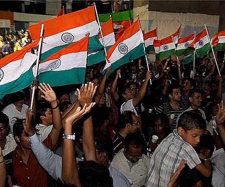 Supporters of social activist Anna Hazare wave Tricolours as the take part in a candle light vigil in Chennai on Thursday.
