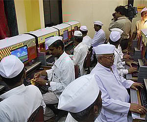 Dabbawallas at the computer training centre at Agrawal Institute of Management and Technology. (IANS Photo)