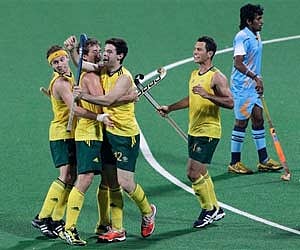 Australia's Trent Mitton (12) celebrates with teammates after his team's goal against India in their men's hockey match. (AP)