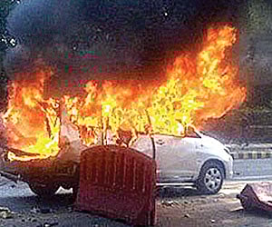 TERROR STRIKE: An Israeli embassy vehicle up in flames after a bomb attack on it near the high-security Race Course Road area in New Delhi on Monday.