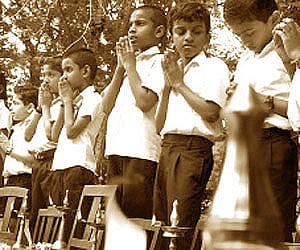 Students of Govt Model HS LPS & Nursery at Thycaud folding their hands in front of lit lamps during the ‘Aksharapolivu’ programme on Friday| BP Deepu.