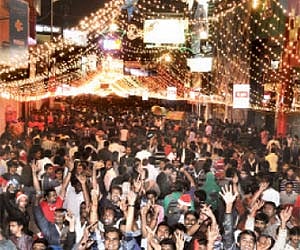 Revellers break into a jig and cheer at the stroke of 12 on Brigade Road in Bangalore on Saturday| Sudhakar Jain.