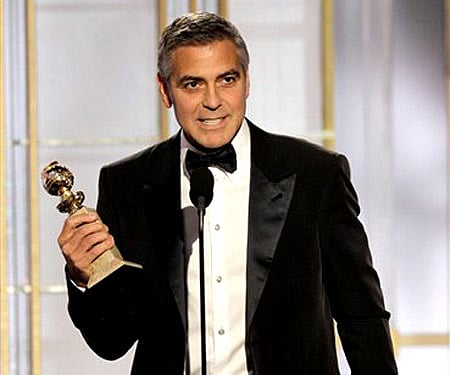 George Clooney poses backstage with the award for Best Actor in a Motion Picture Drama for ‘The Descendants’ (AP Photo/Mark J. Terrill).