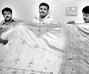 File photo of weavers displaying a Dharmavaram silk saree. | Express Photo
