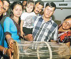 Visitors admiring the drum at the government museum