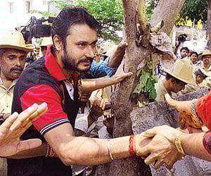 Actor Darshan meeting his fans outside his residence in Bangalore on Saturday | Express Photo