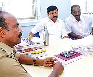 game’s up: Ex-minister for highways M P Saminathan (second from L) at the Tirupur SP office on Monday.
