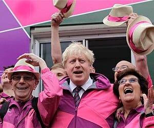 Mayor of London, Boris Johnson, center, poses with some of the London Ambassadors during the launch of their uniform outside Wimbledon station. AP