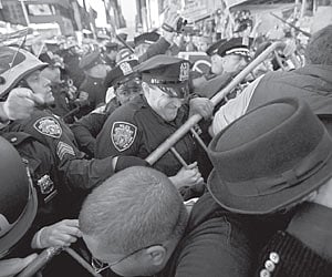 PEOPLE POWER: Occupy Wall Street participants try to push through a police barricade to take their demonstration onto the street in Times Square.