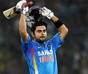 Virat Kohli gestures after scoring a century during the second one-day international cricket match against England in New Delhi, Monday. (PTI)