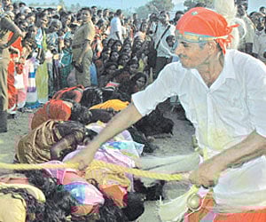EXORCIST: Women being whipped by a priest in front of a temple in Namakkal district. | Express Photo