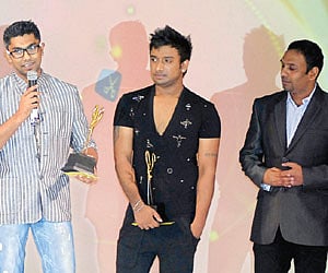 Vivek Karunakaran (left) receives an award.