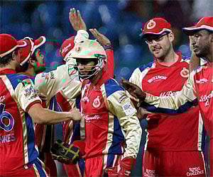 Royal Challengers Bangalore Syed Mohammad with team mates celebrate the wicket of Michael Klinger of South Australian Redbacks. (PTI)