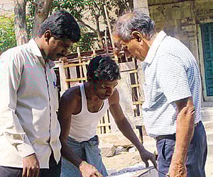 Dr T Satyamurthy inspecting stone engravings during one of his visits to a heritage site.