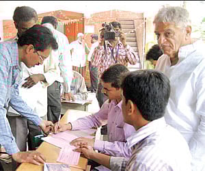 Chukka Ramaiah (right) monitors the issuance of application forms at his institute in Hyderabad on Friday.