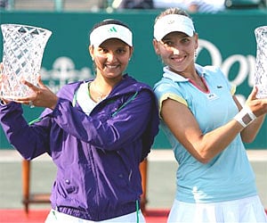 Sania Mirza of India and Elena Vesnina, of Russia hold their trophies after winning the Family Circle Cup tennis tournament in Charleston, Sunday. AP