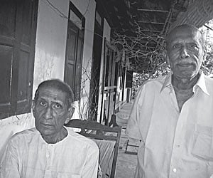 Peter Thomas (sitting) and V T Thomas (Toms) at their ancestral home in Veliyanad | ENS