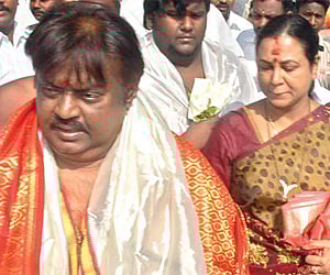 Vijayakant and wife Premalatha entering the inner sanctum of the Kamakshi Amman Temple on Saturday.