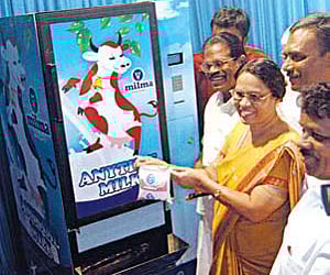 Mayor Mercy Williams inaugurating the Anytime Milk vending machine launched by Milma in Kochi by taking a packet of milk from the machine on Wednesday