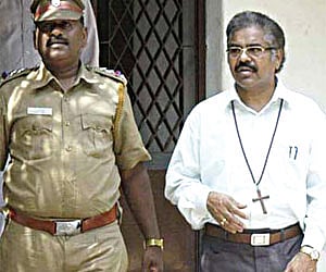 A file picture of Bishop Manickam Dorai being led out of his house after his arrest.