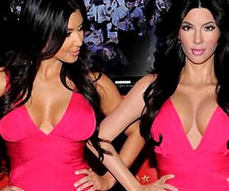 Kim Kardashian, left, unveils her wax figure replica at Madame Tussauds New York on July 1, in New York. (AP)