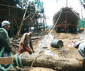 Khalasis launching a dhow at an islet at Chaliyam in Kozhikode district, using traditional methods | K Shijith