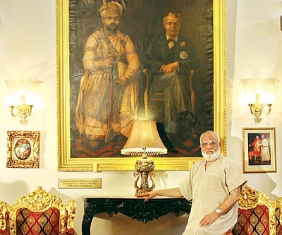 The Prince of Arcot poses by a portrait of an ancestor; ceremonial guards at one of the palace’s entrances.