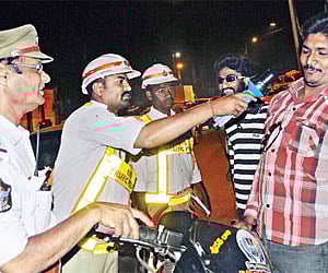A file photo of traffic cops checking on a man who was drinking and driving in the city