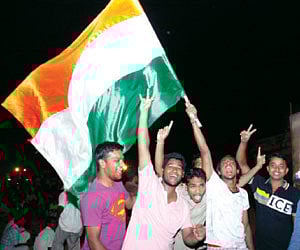Asian Games gold medallist Preeja Sreedharan carrying the National Games flag at University Stadium on Tuesday