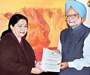 Prime Minister Manmohan Singh receives a memorandum from Chief Minister J Jayalalithaa during a meeting in New Delhi on Tuesday. PTI