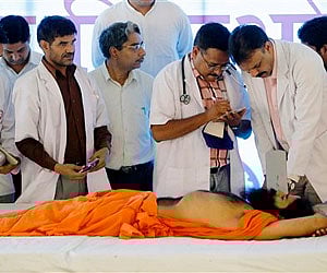 A doctor inspects the health of  yoga guru Baba Ramdev at Ramdev's ashram in Haridwar, Friday, June 10, 2011. AP