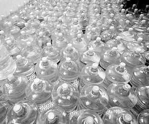 A girl drinking water from a ‘chelama’ (water pit on the river bed) at Vellaturu in Krishna district | CH Narayana Rao