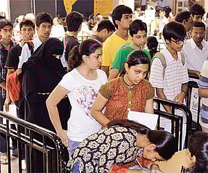 Admission aspirants queue up to fill forms for PU and degree courses at Jain College in Bangalore.