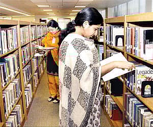 A file picture of people browsing through books in a library.