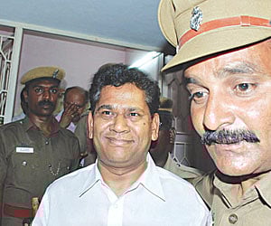 GAME’S UP: Lottery king Santiago Martin (C) in the custody of Salem Police on Saturday.