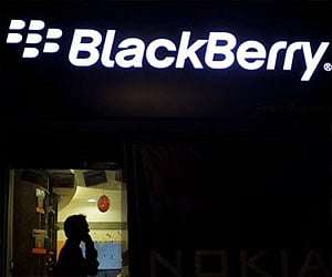 A man chats on BlackBerry mobile. (File photo: AP)