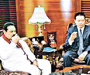 Chinese women wearing saree serving tea to the visiting Sri Lankan President Mahinda Rajapaksa and others at the Foreign Studies University in Beijing