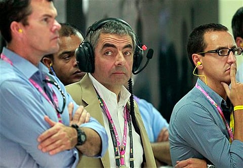 British actor Rowan Atkinson visits McLaren garage during Indian F1 Grand Prix. AP