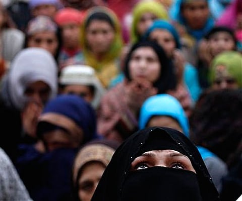 A Kashmiri Muslim woman looks up for prayers at the Hazratbal shrine. AP